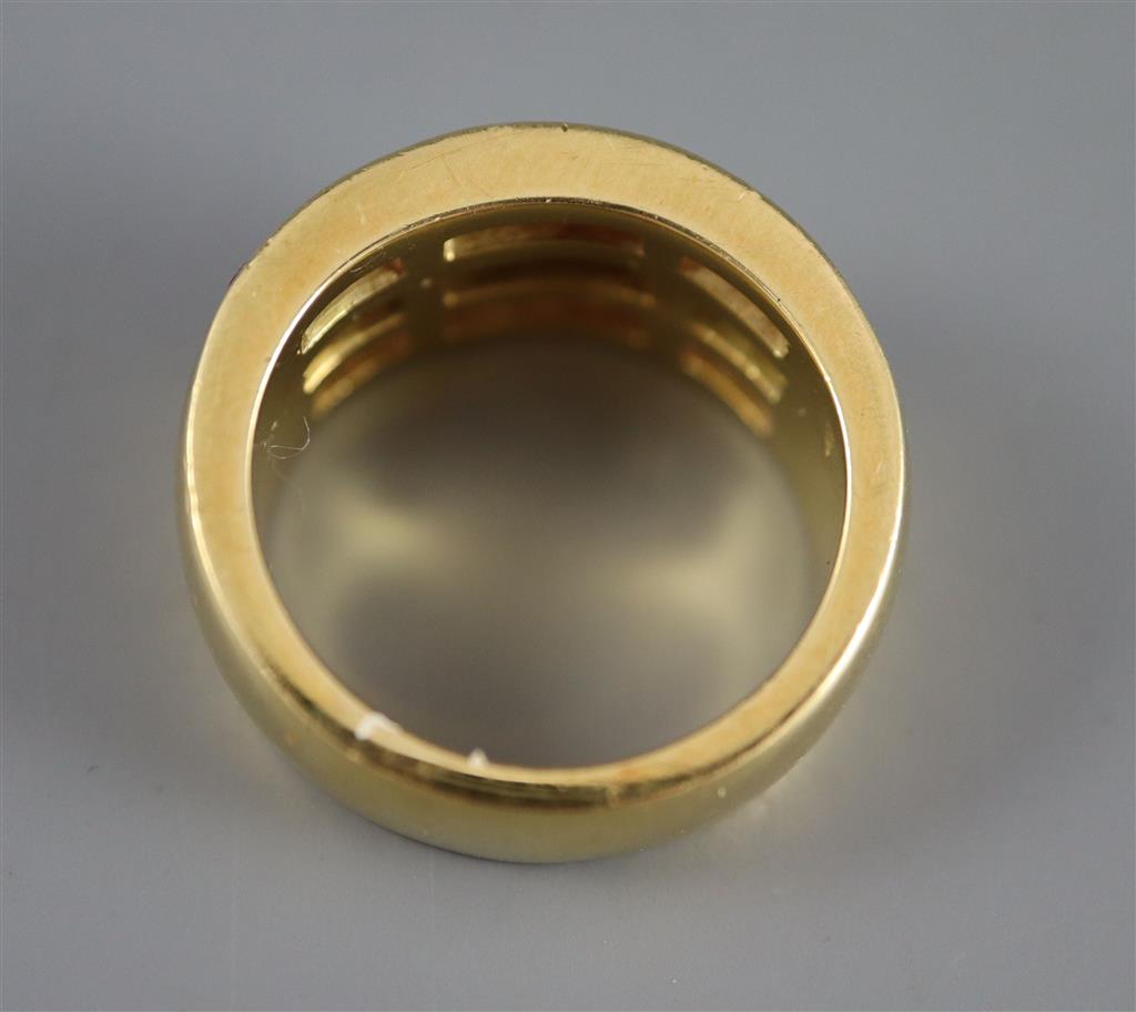 A modern 18ct gold, diamond and pink sapphire set three row dress ring,